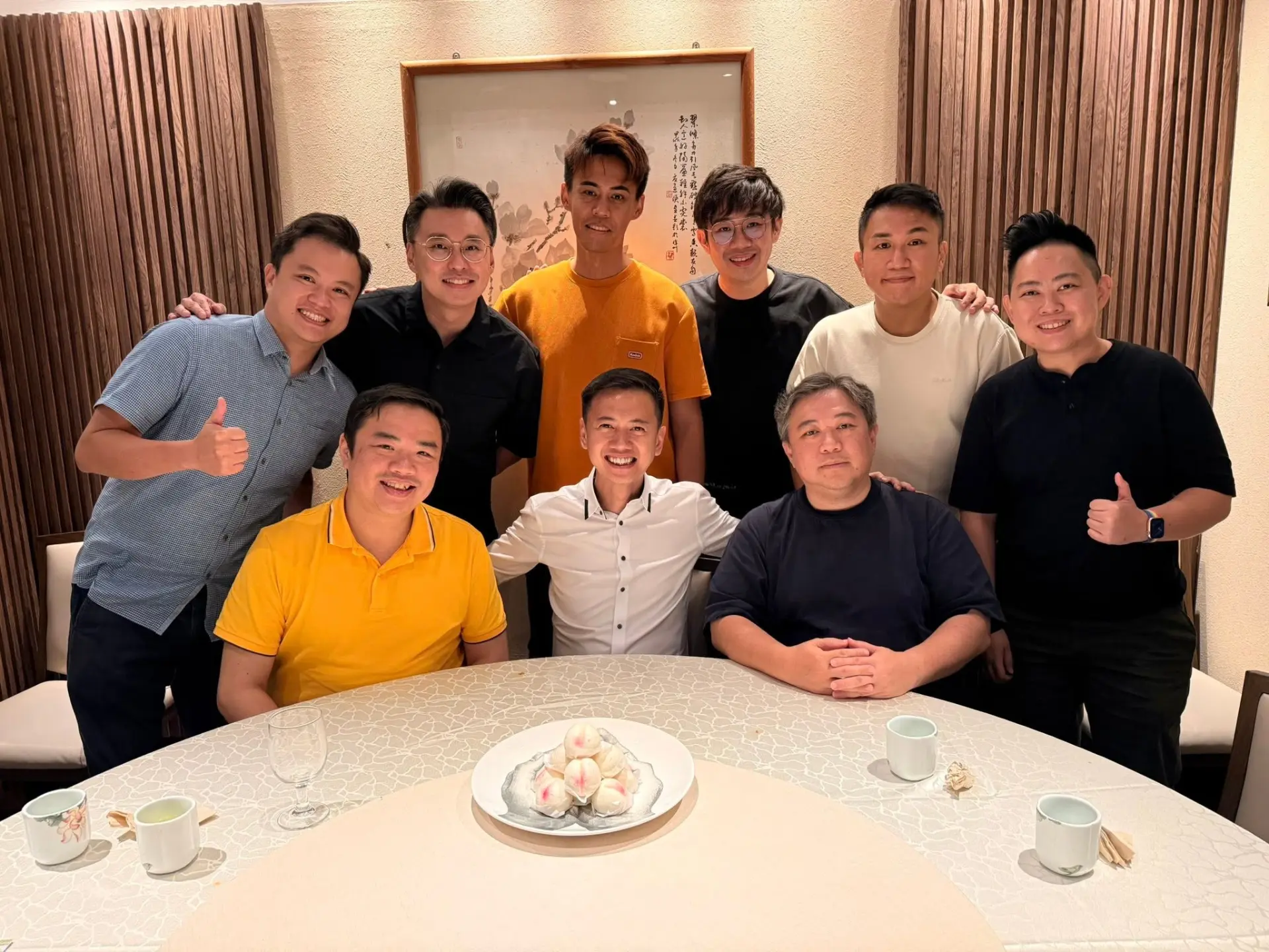 Fendy and team gathered around a round table for a celebration dinner