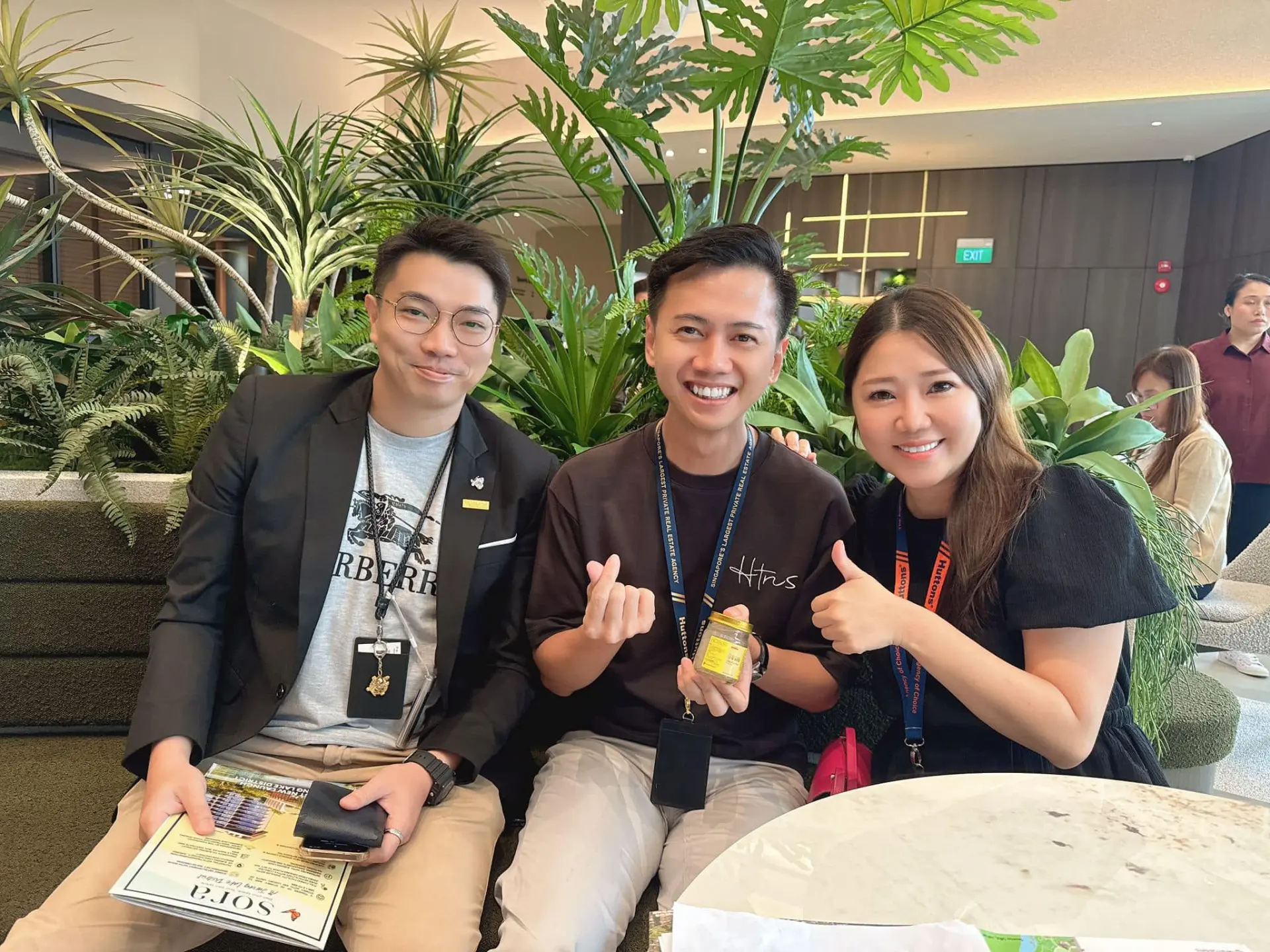 Three colleagues relaxing together on a green lounge