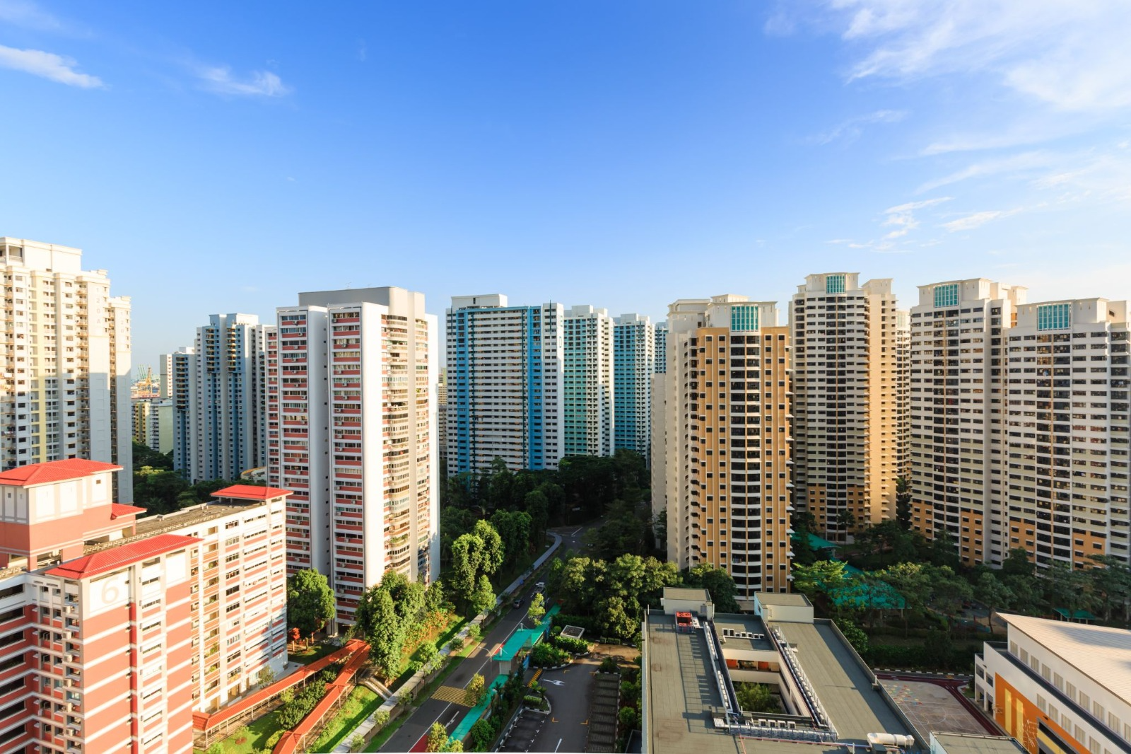 HDB residential blocks in Singapore under a blue sky